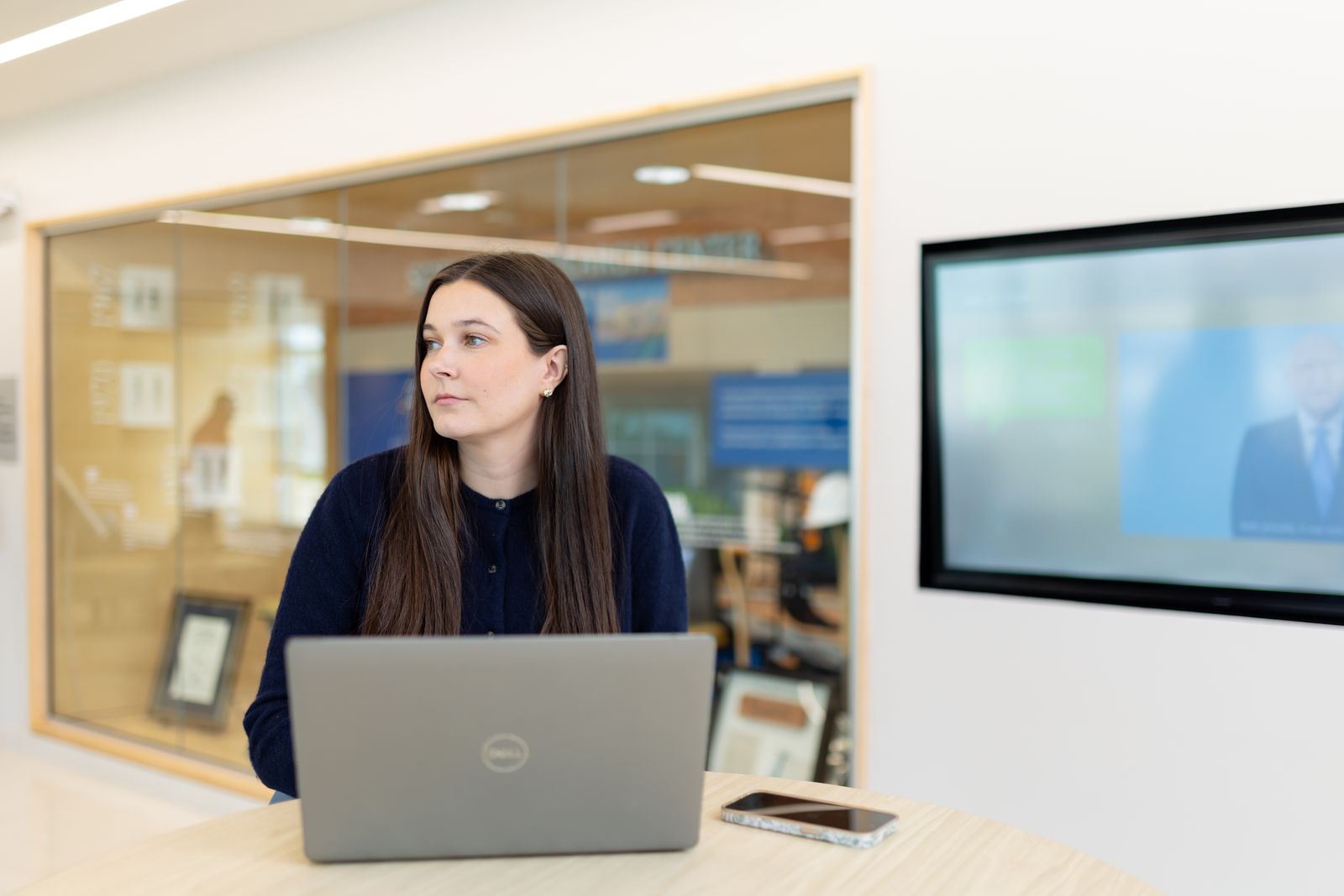 Student works at a laptop in a bright campus study space during a virtual tutoring session.