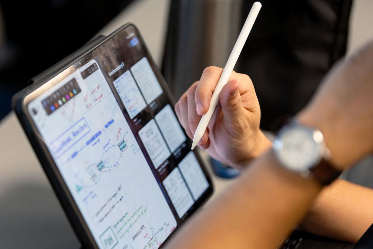 A clinician taking notes on a tablet during an on-demand course